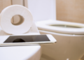 Phone use on the toilet stock image