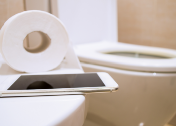 Phone use on the toilet stock image
