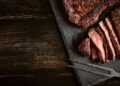 Stock image of red meat steak on a wooden background